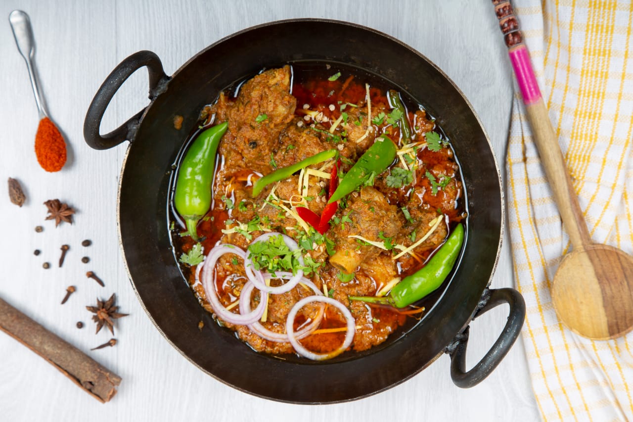 A sizzling karahi dish, a flavorful Pakistani stew.