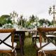 Decorated with floral compositions wedding celebration table with brown chiavari chairs guests seats outdoors in the gardens